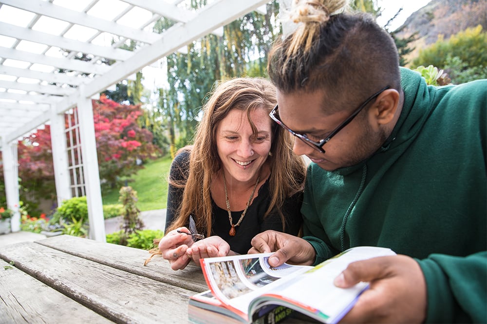 Students studying a dragonfly