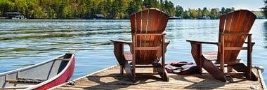 chairs at end of dock on lake