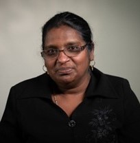 Image of Dr. Pamini Thangarajah, a smiling woman in a black shirt