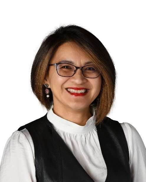 Dr. Naowarat (Ann) Cheeptham, a smiling woman in a black vest and white blouse