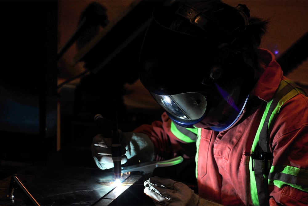 Student wearing welder's mask