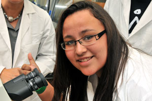 photograph of student with microscope