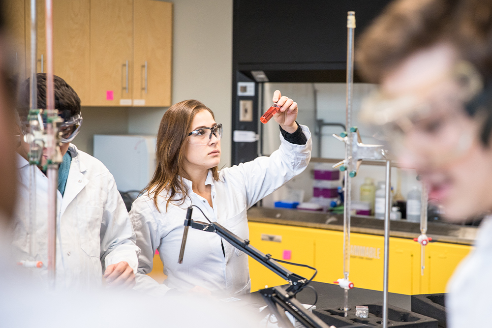 student analyzing test tube sample