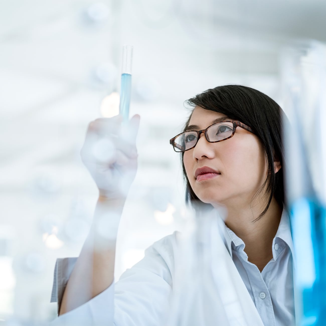 Woman looking at test tube