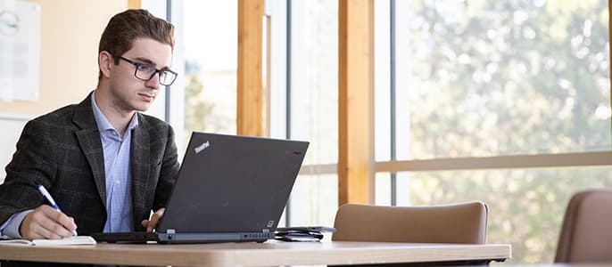 student studying at laptop