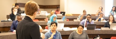 Instructor taking question from student during lecture