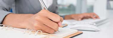 person taking notes at desk