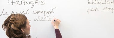 teacher writing on whiteboard