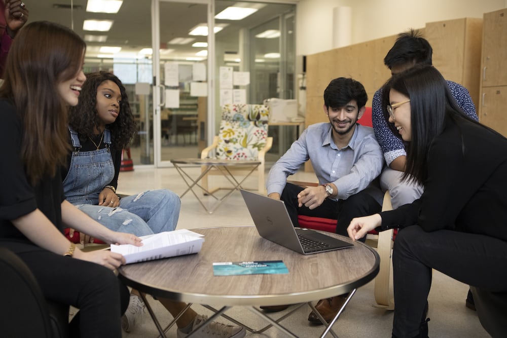 Side photo - Students in a group discussing