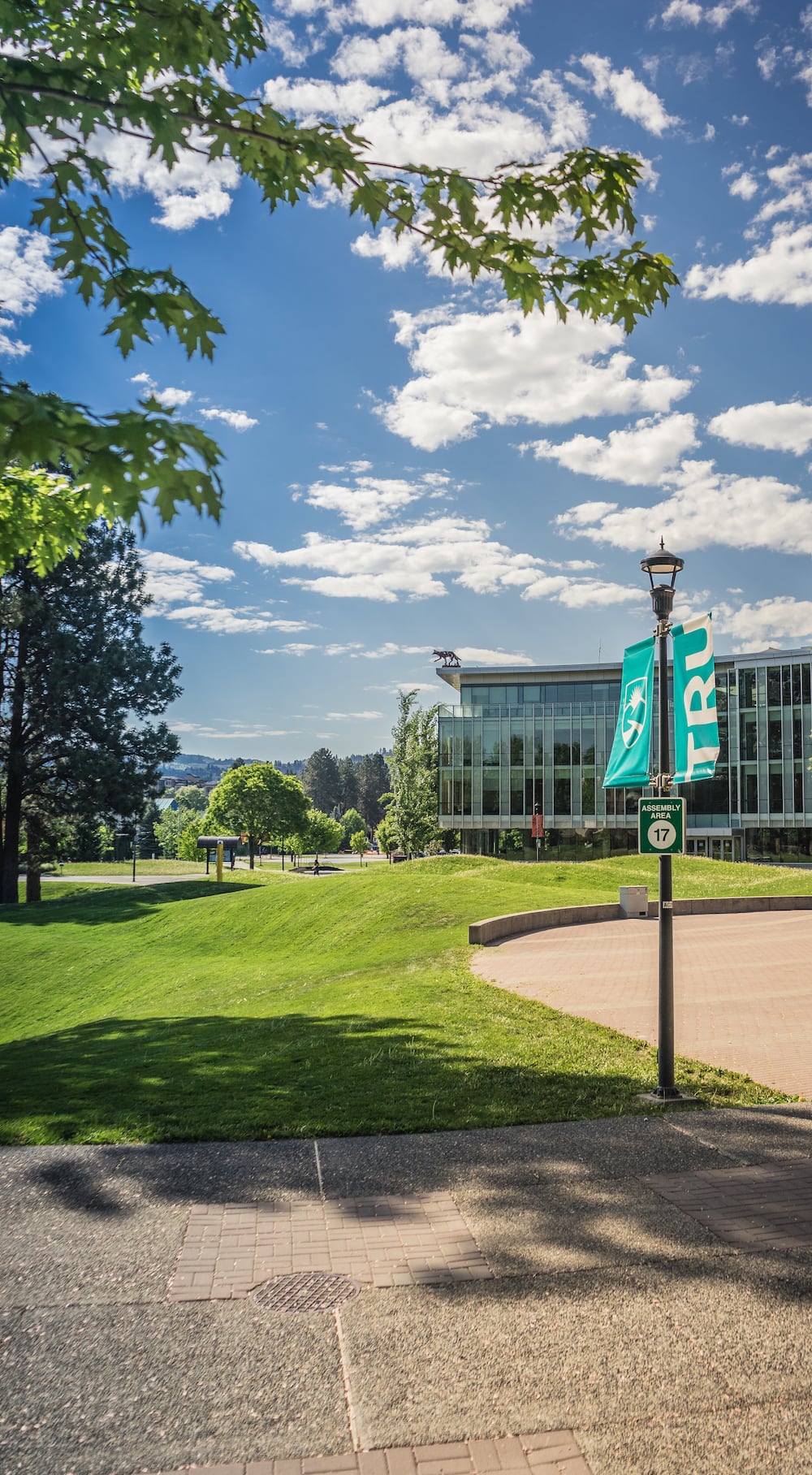 Campus photo with TRU signs on a post